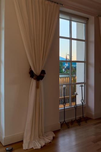 a curtain in a room with a large window at Bergkranz Apartments in Seefeld in Tirol