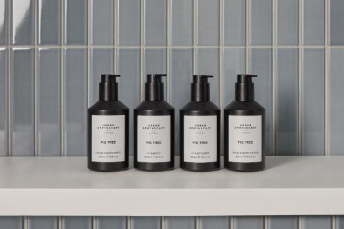 four bottles of wine sitting on a shelf at Hotel Indigo London Clerkenwell by IHG in London