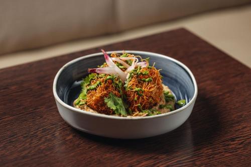 a bowl of food sitting on a table at Hotel Indigo London Clerkenwell by IHG in London
