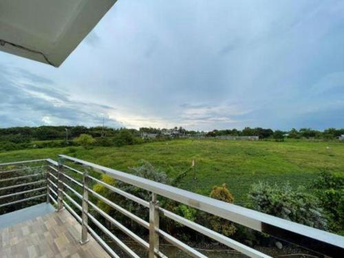 a view of a field from the balcony of a house at Pilot Hotel in Alaminos