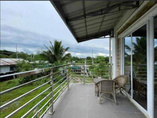 a porch with a table and a chair on a balcony at Pilot Hotel in Alaminos