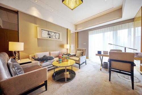a living room with a couch and a table at Hilton Dalian in Dalian