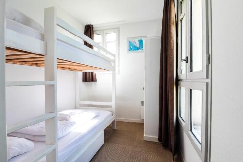 a bedroom with two bunk beds and a window at Maya - Piscine - Calme - Parking in Baden