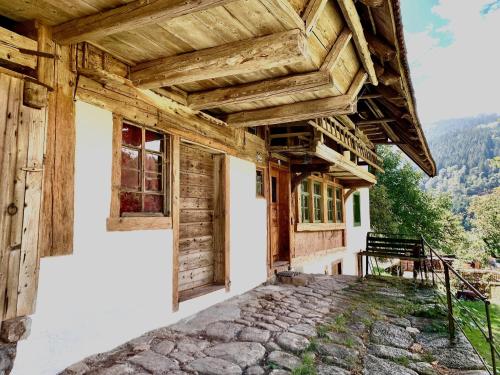 a house in the mountains with a wooden roof at Ferienhaus Hederle in Elzach