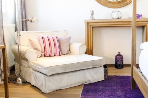 a chair with a pillow on top of a ottoman at Gästehaus im Weingut am Nil in Kallstadt