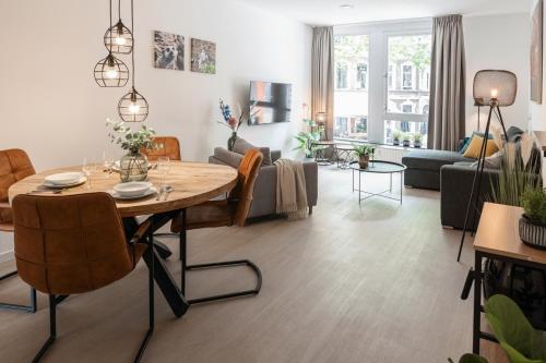 a living room with a table and a couch at Prime Location apt w wifi & near poppodium 013 in Tilburg