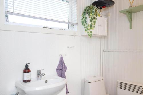 a bathroom with a sink and a toilet and a window at 16608-1-Farevejle-Horager-8 in Kårup