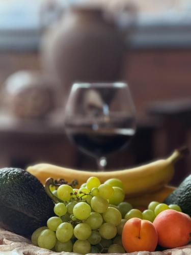 a bunch of fruit and a glass of wine at Lidori Mani in Akhíllion