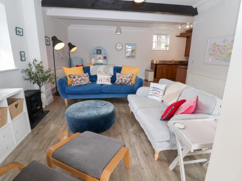 a living room with a blue couch and a table at Old Felixstowe, Bath Road in Felixstowe