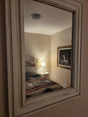 a reflection of a bedroom with a bed in a mirror at Hacienda del Piero in Poppendorf im Burgenland
