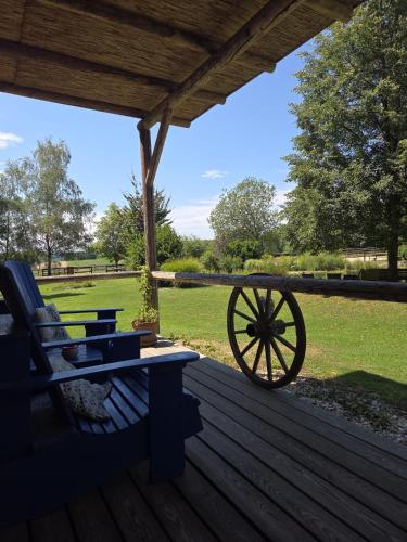 a wooden deck with a bench and a cannon at Hacienda del Piero in Poppendorf im Burgenland