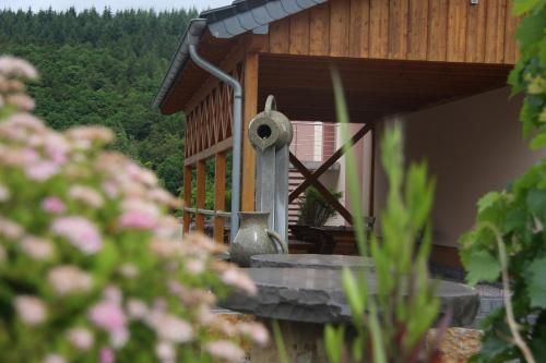 a porch of a house with a vase on it at Bistro im Ring in Quiddelbach