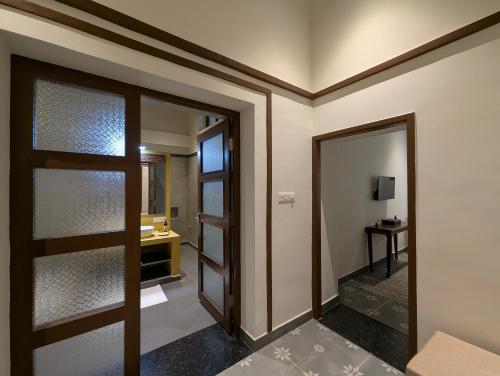 a hallway with a door and a mirror at Nilayam by Luxunlock Private Villas in Jāmb