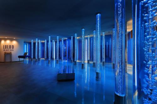 a row of blue glass columns in a room at Shin Toji Hotel Lulud in Nakanojo