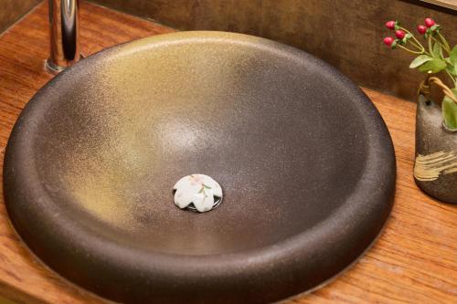 a stone in a frying pan on a wooden table at condominium hotel KEYAKIAN Tokyo Nihonbashi in Tokyo