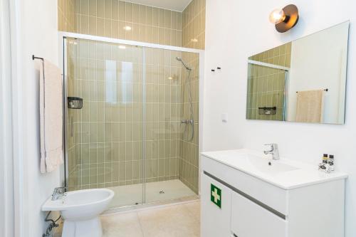 a bathroom with a shower and a sink and a toilet at CICIOSO flats João de Deus 1 in Évora