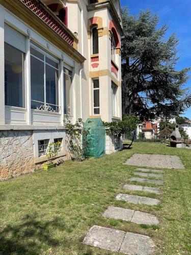 a house with a grass yard in front of it at Bellavista in Neuchâtel