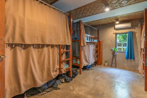a room with a curtain and some shelves at Sinag Hostel in General Luna