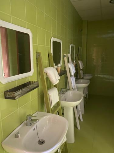 a bathroom with four sinks and mirrors in a room at Hostal Las Viñas in Aguilar de la Frontera