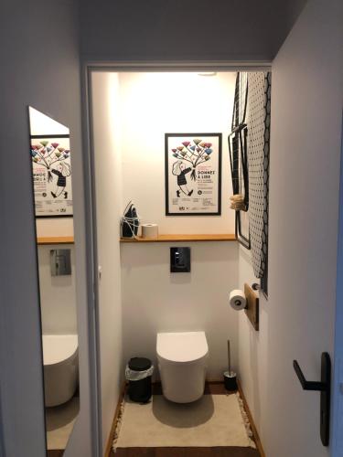 a bathroom with a toilet and a sink at Les gites du renard souriant in Cussy-en-Morvan