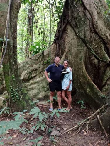 a man and a woman standing in front of a tree at Amornkeeree Khao Sok Camping in Khao Sok