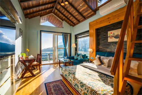 a bedroom with a bed and a large window at Jr Hotel Dharamshala in Dharamshala