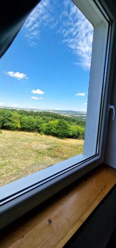 a window with a view of a field at Panoráma vendégház in Pécsely