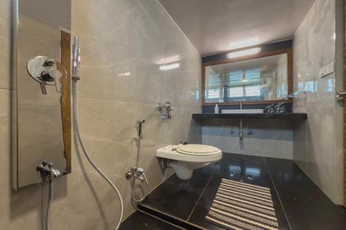 a bathroom with a shower and a toilet in it at SaffronStays Hidden Branches -3BR pet-friendly villa with infinity pool & forest views in Khandala in Lonavala