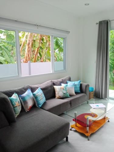 a living room with a couch and a glass table at Tranquility in Bangrak Beach