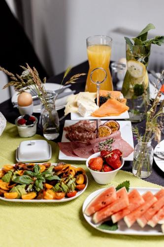 a table with plates of food on a table at Gutshof Zum Adlernest in Arnsnesta