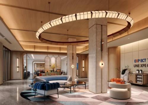 a lobby of a hotel with a couch and chairs at Holiday Inn Express Qingdao Downtown by IHG in Qingdao