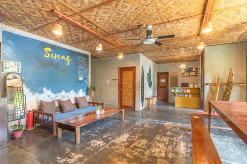a living room with a couch and a table at Sinag Hostel in General Luna
