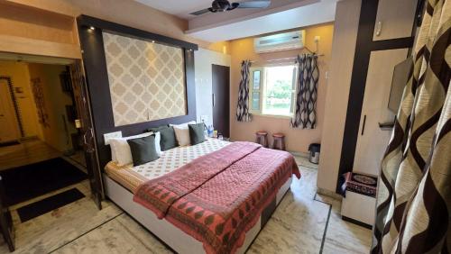 a bedroom with a bed with a red blanket at Oolala - Your lake house in the center of Udaipur in Udaipur