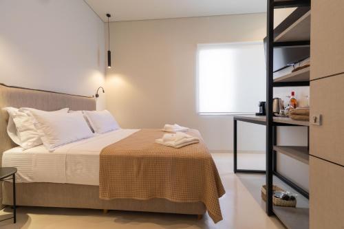 a bedroom with a bed and a book shelf at Alkida Luxury Rooms Tolo in Tolo