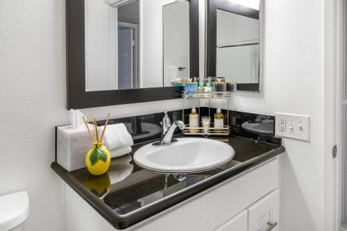 a bathroom with a sink and a mirror at Westlake Village Escape 2 Bedroom 2 Bath with Pool & Jacuzzi View! Welcome Champagne in Westlake Village