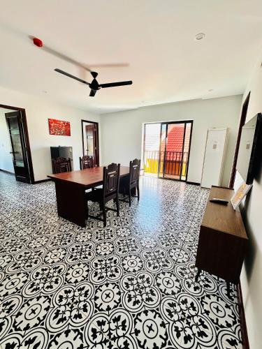an office with a table and chairs in a room at Laa House in Hoi An