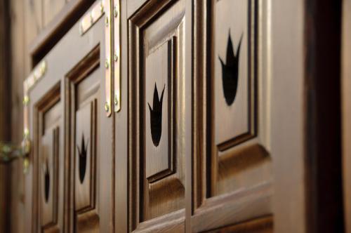 a wooden door with black designs on it at Antiklak in Doboz