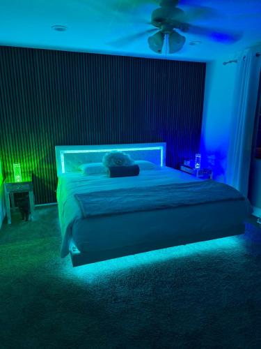 a bedroom with a bed with a blue light at Westlake Village Escape 2 Bedroom 2 Bath with Pool & Jacuzzi View! Welcome Champagne in Westlake Village
