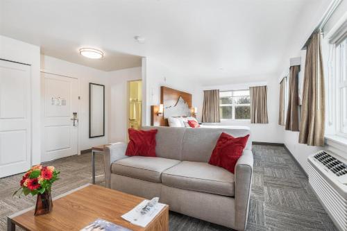 a living room with a couch and a table at Marshall Suites Bainbridge Island, SureStay Collection by BW in Bainbridge