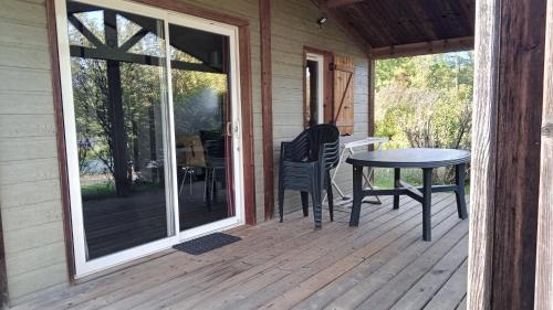 a screened porch with a table and chairs on it at Terres de France - Les Hameaux de Pomette in Marminiac