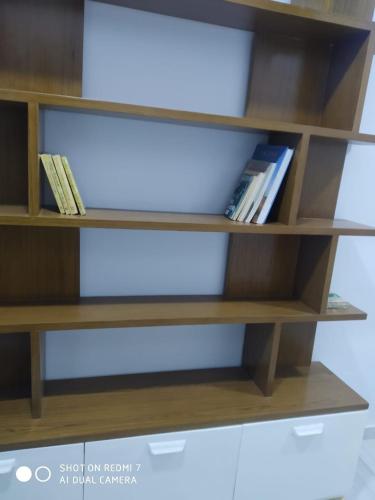 a book shelf with some books on it at Maat apartment in Luxor