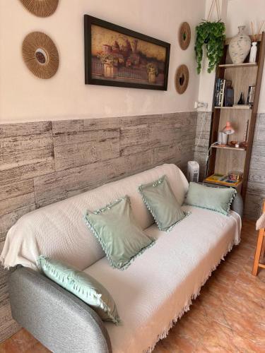 a living room with a couch with pillows on it at Casa rústica y luminosa in Deltebre