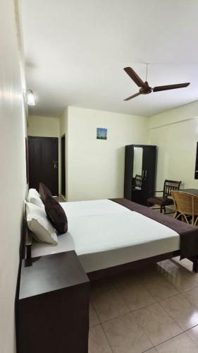 a large bed in a room with a ceiling at UPPERCREST RESIDENCY PALA in Pala