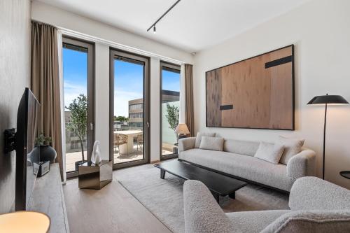 a living room with a couch and a table at Voya Residence Zenit Royal - Luxury Apart Hotel Rooftop Views & Concierge in Luxembourg