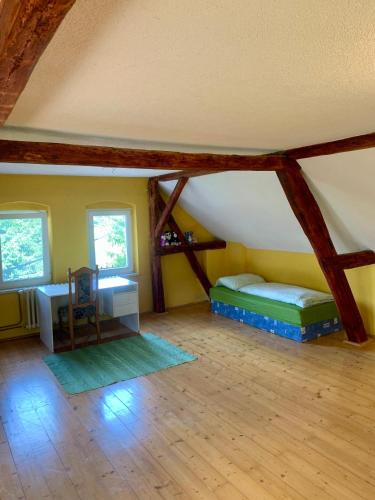 an attic room with two beds and a desk at Foistovic Ranč in Staré Sedlo