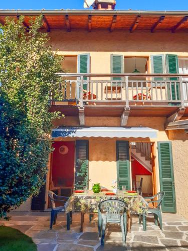 a patio with a table and chairs in front of a building at Villino Lavarello in Verbania