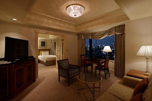 a living room with a room with a bed and a television at Rihga Royal Hotel Tokyo in Tokyo