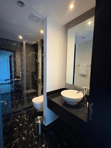 a bathroom with two sinks and a shower at Seef View Apartments in Manama
