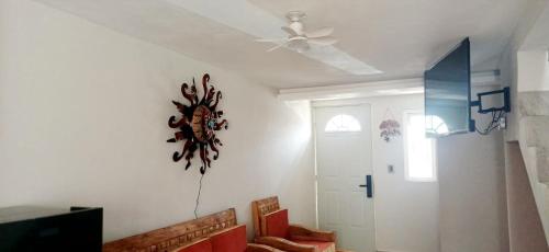 a living room with a ceiling fan and a couch at Casa del Sol in Toluca