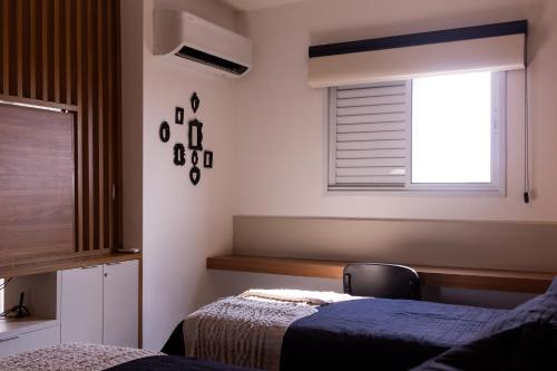 Ένα ή περισσότερα κρεβάτια σε δωμάτιο στο Loft Super Aconchegante